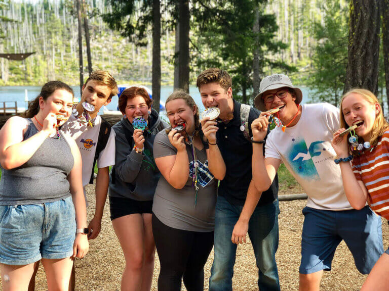 A group of student leaders mugs for the camera at Camp Tamarack