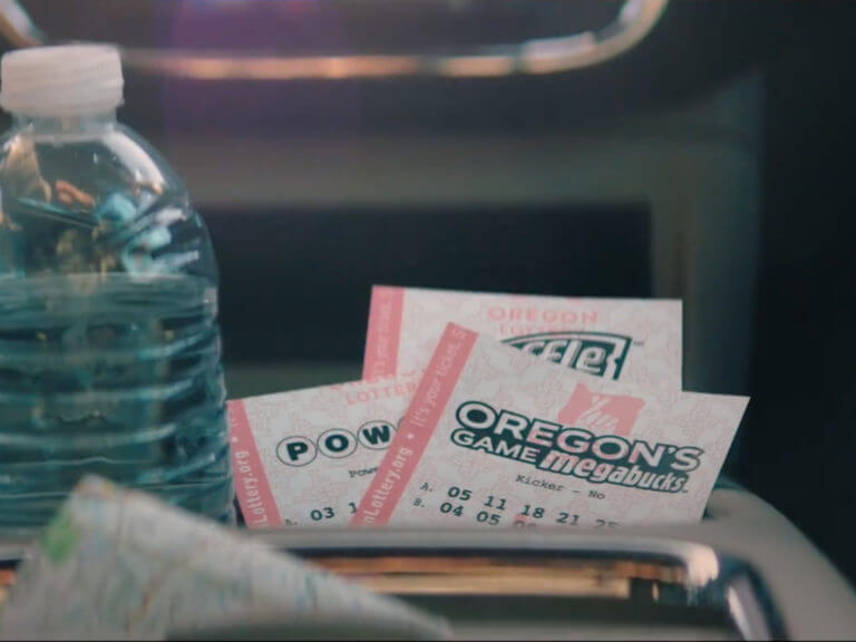 Oregon Lottery Megabucks ticket in cupholder of car