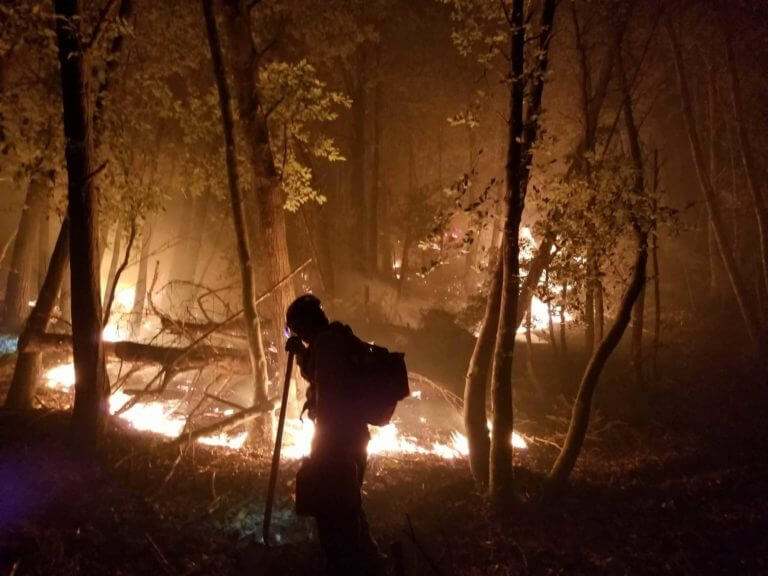 fireman tending to controlling fire