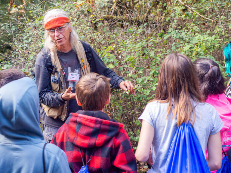 Outdoor Teacher talking about local plants to group of students