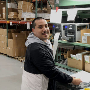 Person smiling at warehouse mail counter