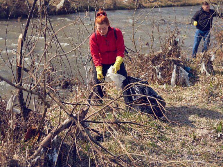 Volunteers clean a riverfront