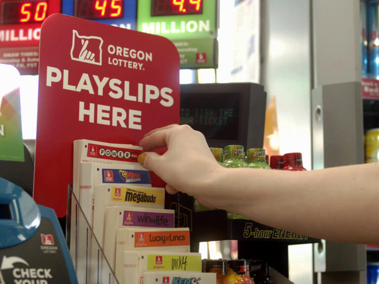 hand reaching for playslip at convenience store counter