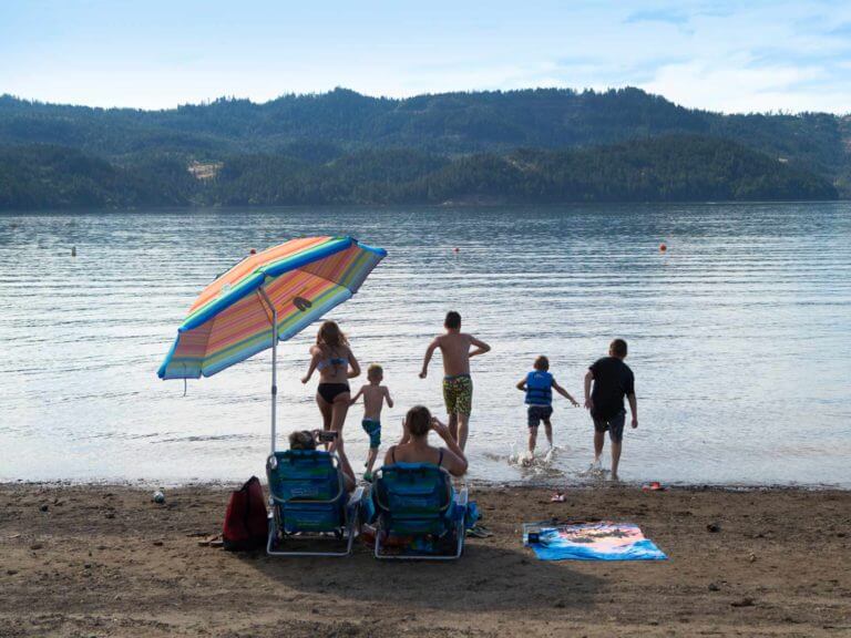 People playing on a lake beach