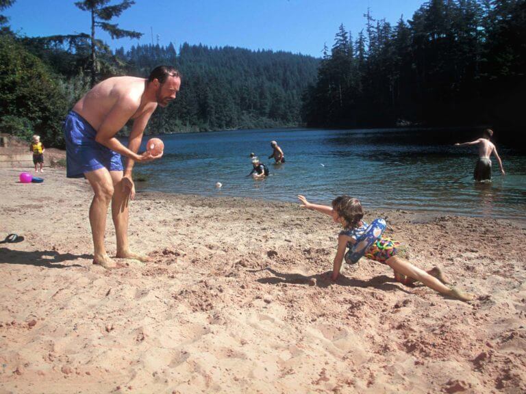 man and child playing on beach