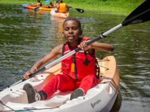 boy kayaking on the river