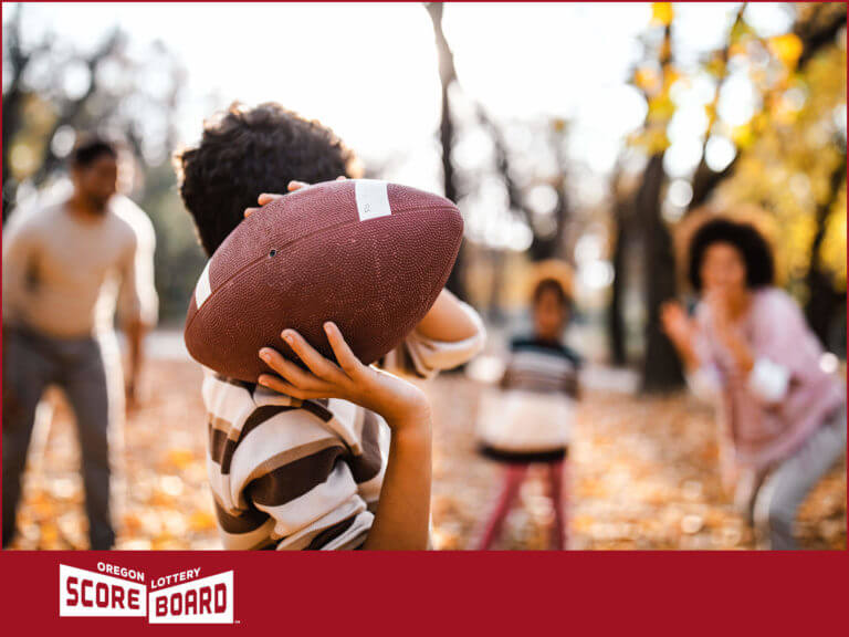 family playing football in backyard