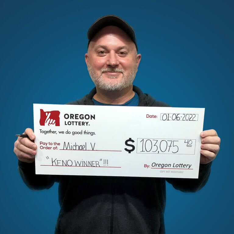 Mike from Medford holds his winning check