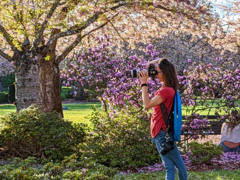 A woman with a large camera takes a picture