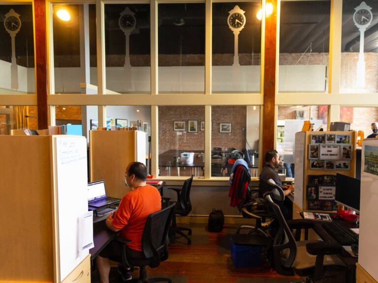 Office workers share a co-working space