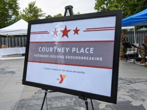 Courtney play sign on display
