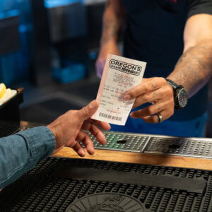 A player purchases a Megabucks ticket from a retailer