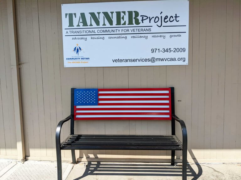 A flag-themed bench in from of the Tanner Project
