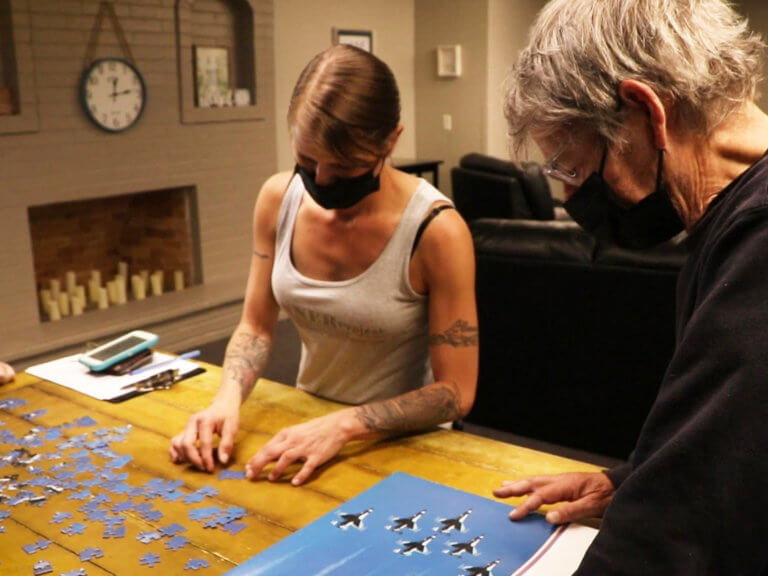 Two people assembling a puzzle at Tanner Project