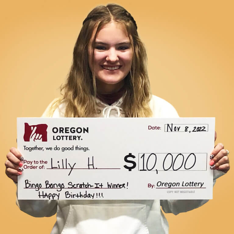 Lilly H holding a check