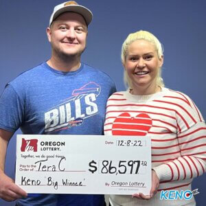 Tera C holding a check