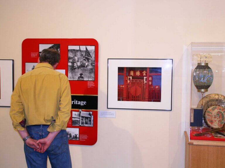 A visitor views an exhibit at Kam Wah Chung Interpretive Center