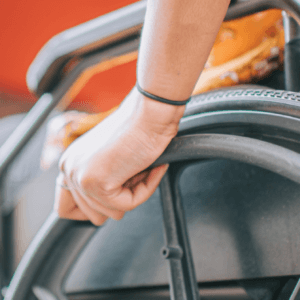 close up shot of a hand on the wheel of a wheelchair