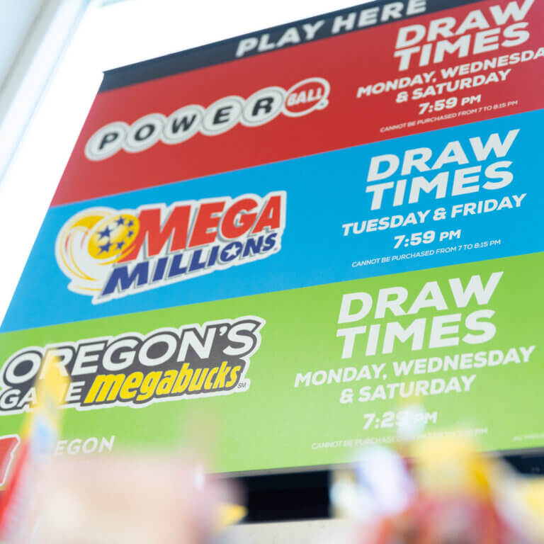 A sign featuring Powerball, Mega Millions and Megabucks drawing times