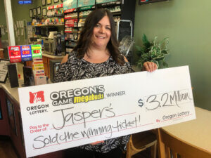 A lottery retailer displays a bonus check.