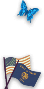 A butterfly hovers over an American and Oregon flag.