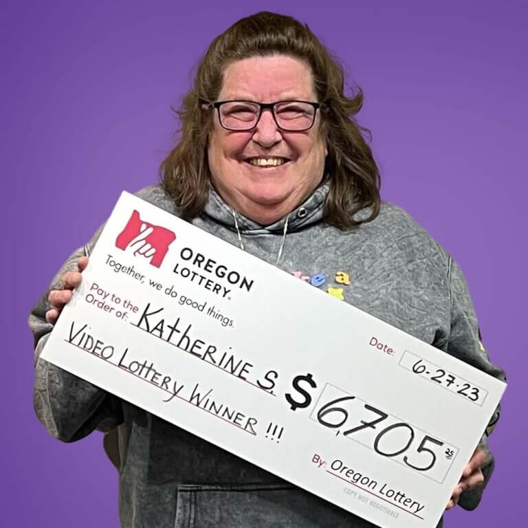 Winner Katherine S holding a check