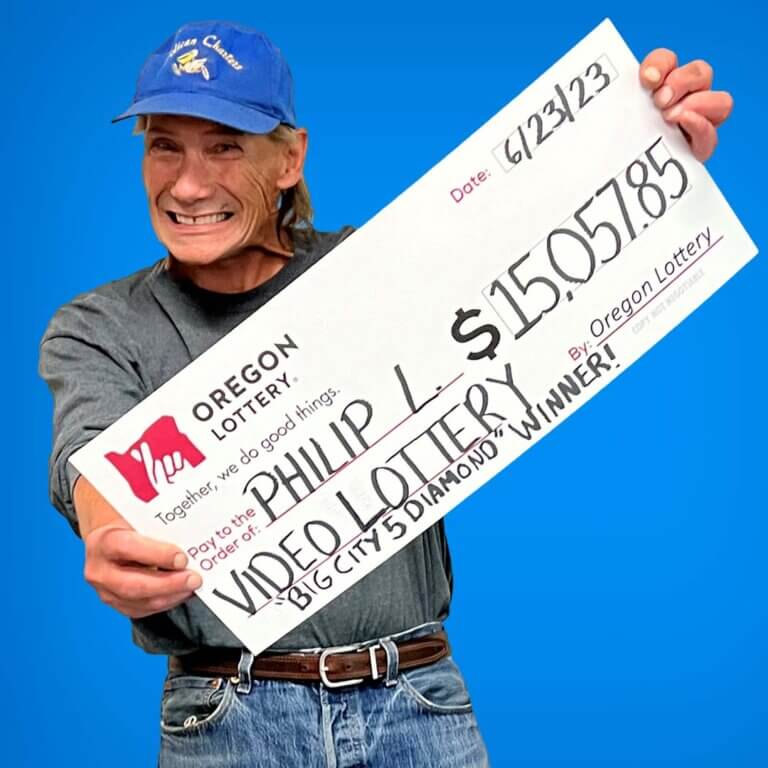 Video Lottery winner Philip L holding a check