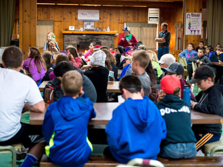 A group of Outdoor School students seated in the dining hall.