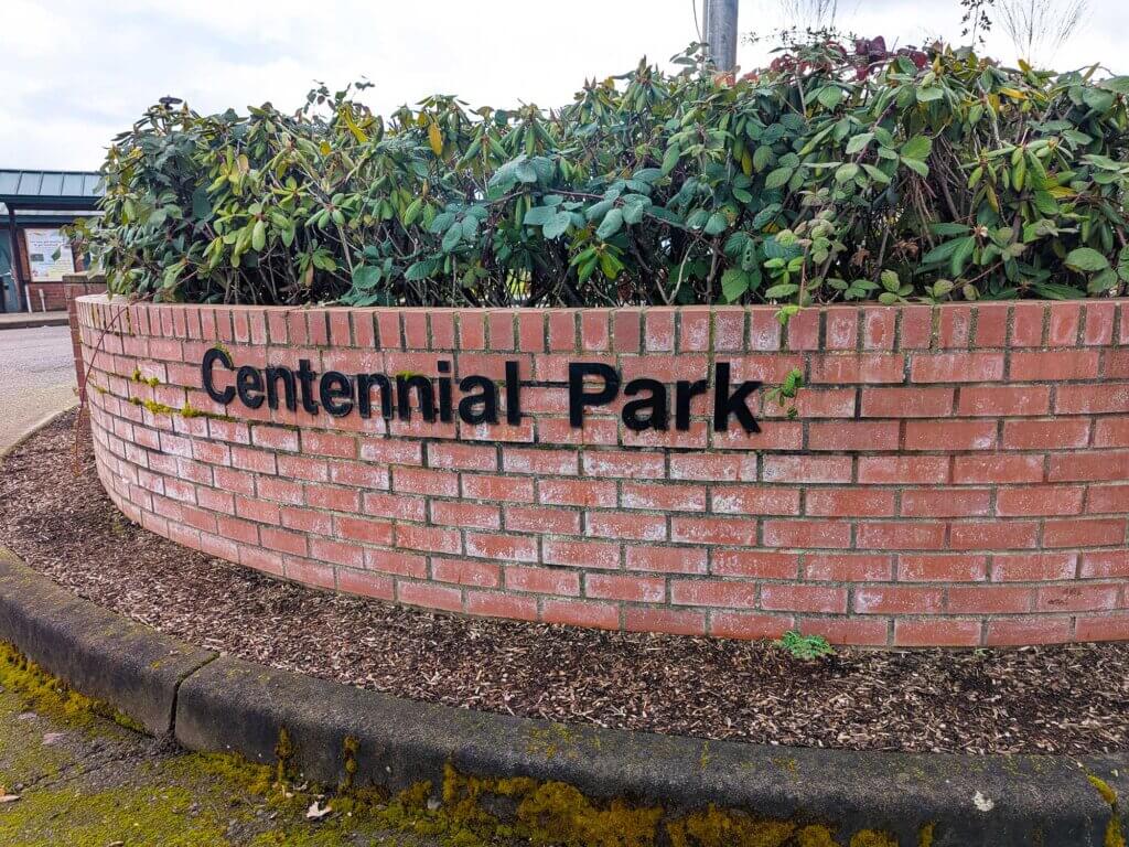Centennial Park sign on a brick retaining wall