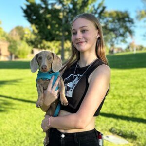 A teen girl poses with her dachshund, Blue Mountain Canine client