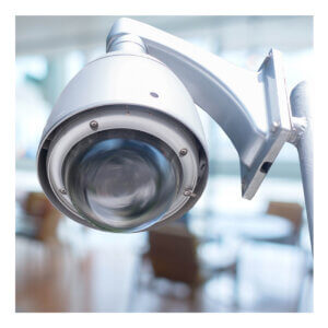 A photograph of an white fish-eye lens security camera
