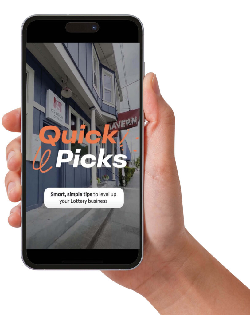 A hand holds a smartphone up to the viewer. On the screen is a still of a vertical video with text that reads: "Quick Picks: Smart, simple tips to level up your Lottery business"