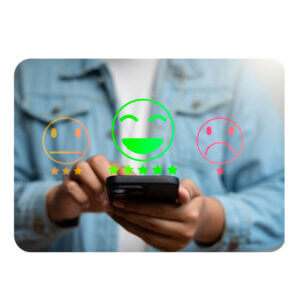 The image is centered over someone's hands holding a cell phone, selecting something on the phone screen. We cannot see the person's face. Overlaid framing the top of the cellphone are illustrations of a Happy face, Neutral face, and Sad face, with 5, 3, and 1 stars beneath.
