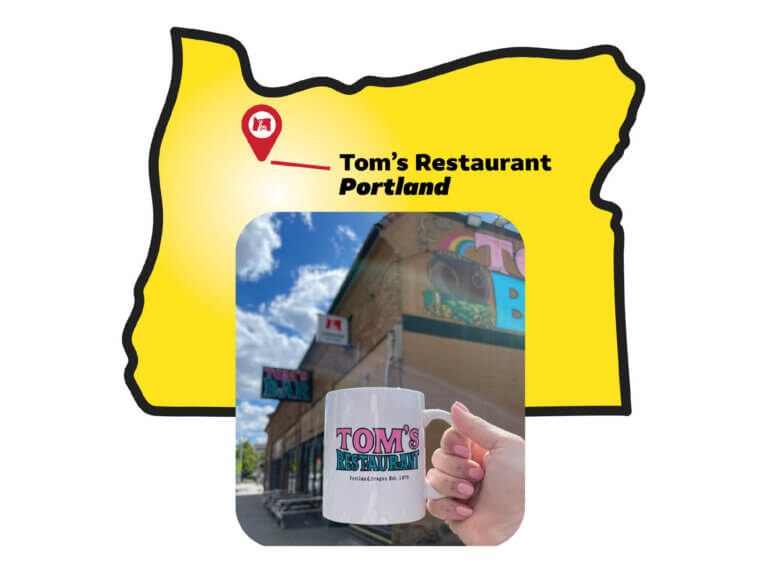 A blocky yellow illustration of the state of Oregon with a red pin dot in the upper left corner. The pin dot has an Oregon Lottery logo in it and points to a caption reading 